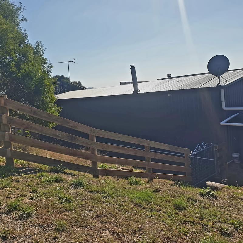 Water tanks secured by timber enclosure